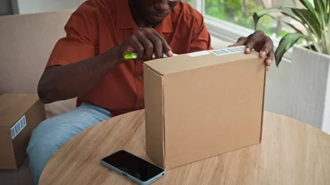 Black Man Checking Parcel with Leather Shoes 库存影片 281710574