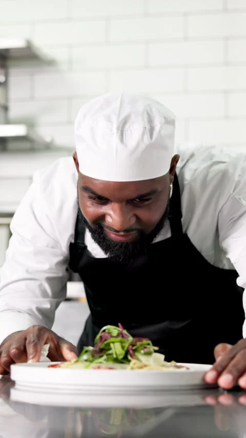 Black man, chef and cooking with plate, presentation or salad for cuisine career Stock Footage 327268700