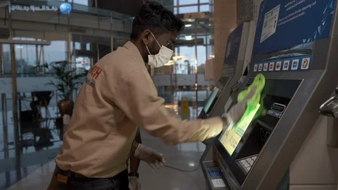 Black man cleaning atm machine in bank. Stock Footage