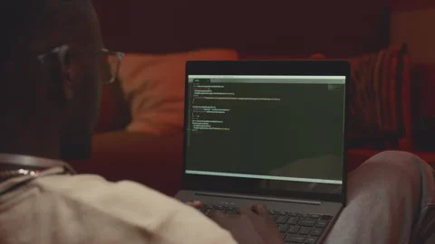 Black Man Coding on Laptop at Neon Dark Room Stock Footage 259166546