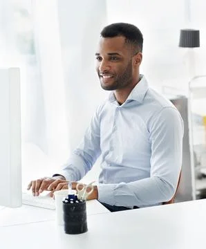 Black man, computer and programming software at desk, online and design website 库存照片
