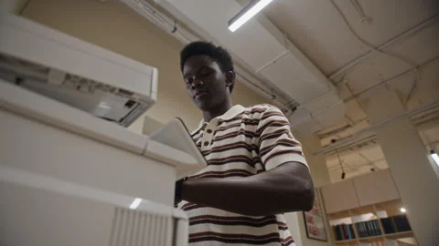 Black Man Copying Documents on Office Printer Low Angle View Vídeos de archivo 343710214