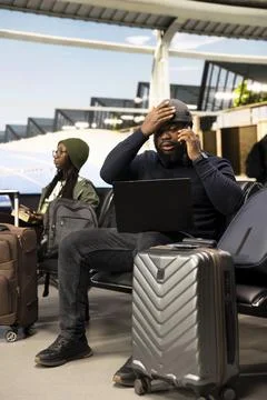 Black man in crisis mode talking on phone call to solve startup mistake Stock Photos