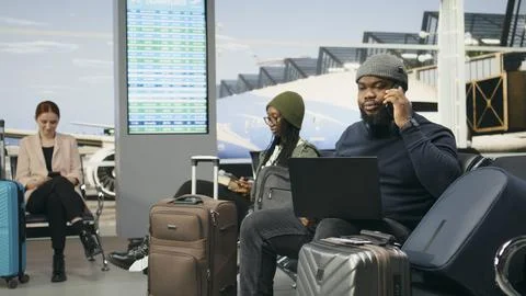 Black man in crisis mode talking on phone call to solve startup mistake Stock Photos