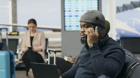 Black man in crisis mode talking on phone call to solve startup mistake Stock Photos