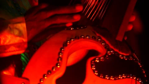 Black man dancing while his fingers are plucking the strings of kora instrument Stock Footage 208940629