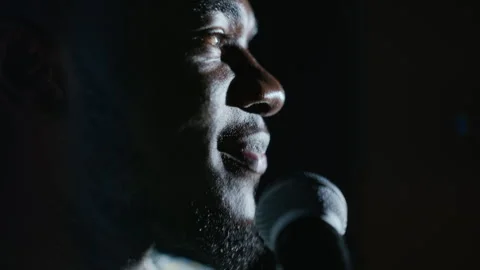 Black Man Delivering Monologue into Microphone on Theater Stage Stock Footage 344529407