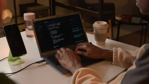 Black Man Developing Software on Laptop at White Desk in Office Stock Footage 336708589