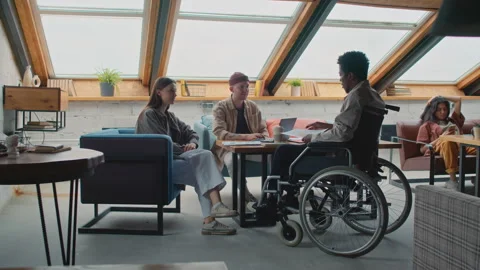 Black Man with Disability Joining Team Meeting at Coworking Space Stock Footage 260387622