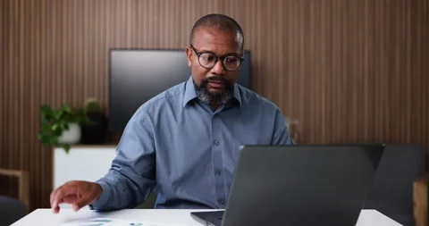Black man, documents and finance with laptop for corporate analysis, budget or Stock Footage 326640378