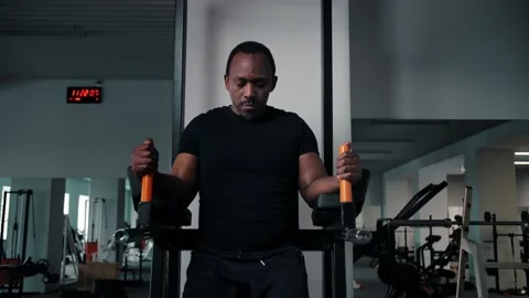 Black man doing abs workout at the gym.Fit guy training abdominal muscle lifting Stock Footage 225714260