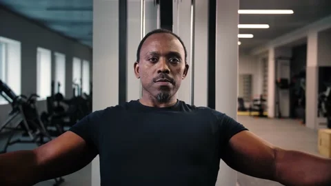Black man doing chest exercise peck deck machine in gym close up.Athlete guy Stock Footage 225717755