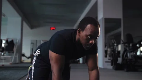 Black man doing exercises of gymnastics in gym.African american do workout Stock Footage 225715068