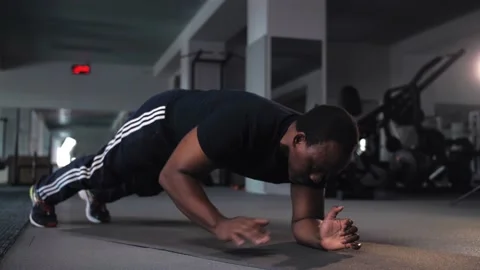 Black man doing exercises of gymnastics in gym.African american do workout Stock Footage 225716352