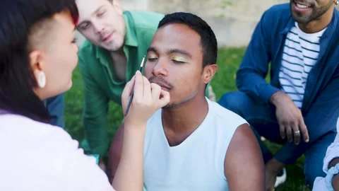 Black man doing makeup with friends. Lgbt fashion concept Stock Footage 307905996