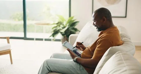 Black man, drawing and remote work in home with tablet, research and sketch.. Stock Photos