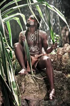 Black man with dreadlocks in the image of the Taino Indian in his habitat Stock Photos