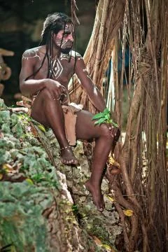 Black man with dreadlocks in the image of the Taino Indian in his habitat Stock Photos