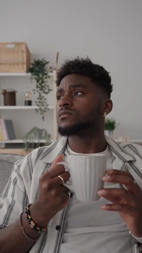 Black man drinking coffee and thinking Stock Footage 240839996