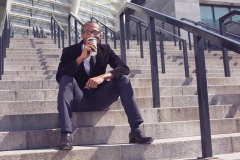 Black man drinking coffee during a lunch Foto stock
