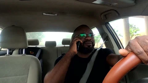 Black Man driving and talking on the phone Stock Footage 236432401