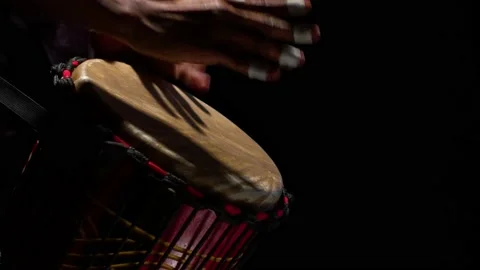Black man drummer rhythmically beats hands on the African drum in the studio Stock Footage 151193868