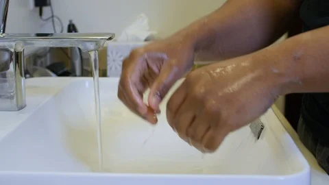 Black man drying wet hands Stock Footage 126743834