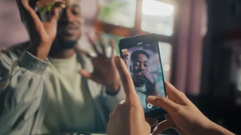 Black man eating a burger while being recorded Stock Footage 275127181