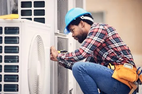 Black man, electrician and maintenance on air conditioner with engineering and Stock Photos