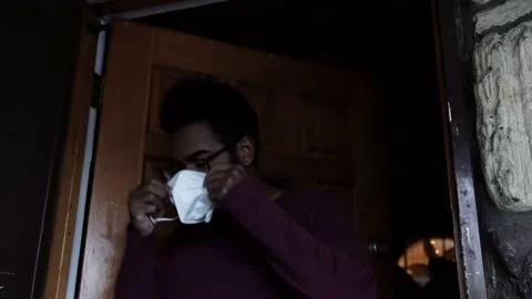 Black Man Exits Home and Wears N-95 Mask Before Leaving House Stock Footage 146164162