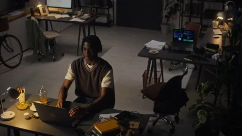 Black Man Experiencing Burnout While Working Late on Laptop in Office Stock Footage 338418476