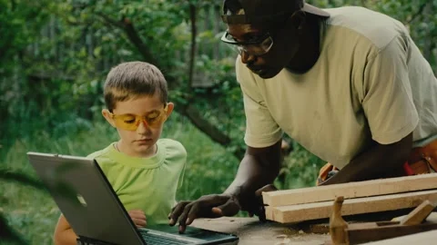 Black man explains to white boy rules of working with wood Video stock 200779682