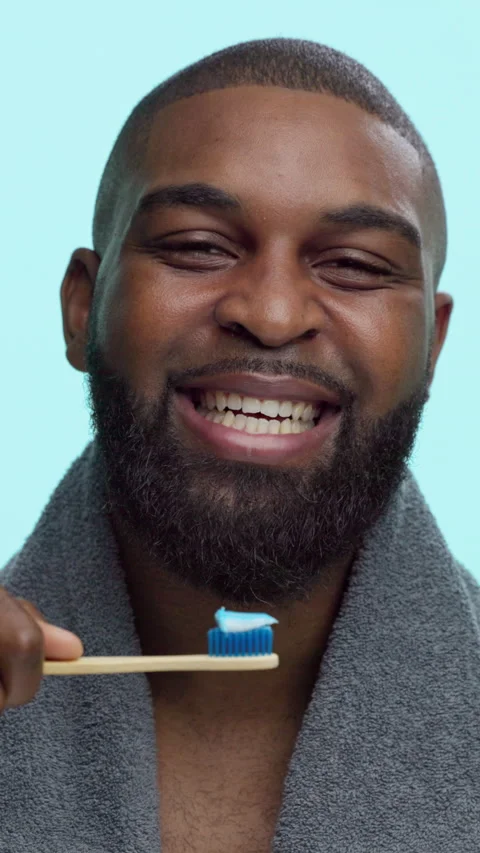 Black man, face and toothbrush for brushing teeth, smile and bamboo on blue Stock Footage 308773969