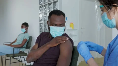 Black man with face mask being vaccinated Stock Footage 233012368
