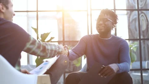 A black man with a folder in his hands shakes hands Stock Footage 263889477