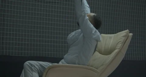 Black man gets happy after crypto pump turning in armchair 스톡 동영상 170478511