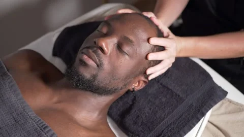 Black man getting a head massage Stock Footage 225038419