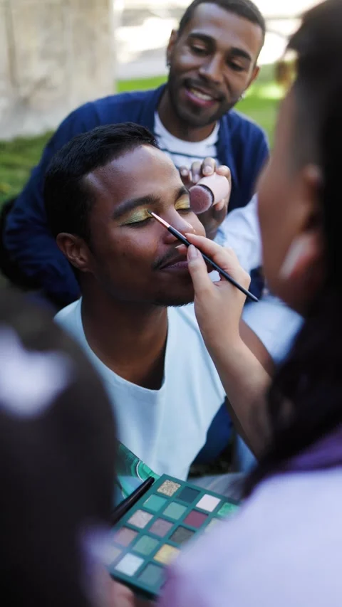 Black man getting makeup with friends at LGBT pride party. Lgbt fashion concept Stock Footage 309043227