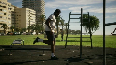 A Black man getting warming up outdoors near the beach Stock Footage 279311476