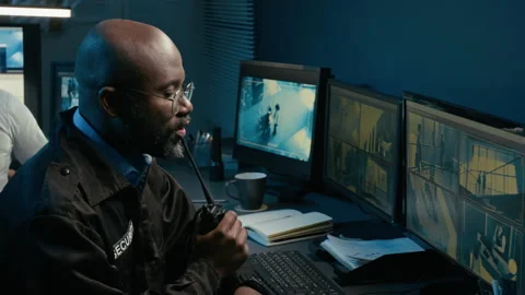 Black Man Giving Commands Speaking Into Portable Radio in Control Room Stock Footage 330609237