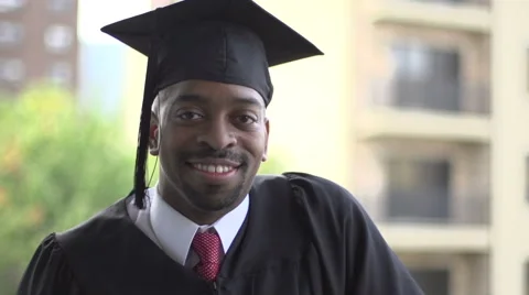 A black man, in graduation gown, smiles ... | Stock Video | Pond5