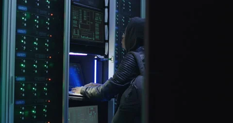 Black man hacking computer system in server room Stock Footage 97207640