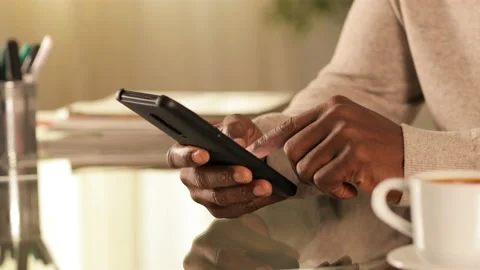 Black man hands texting on phone at home Stock Footage 127596348