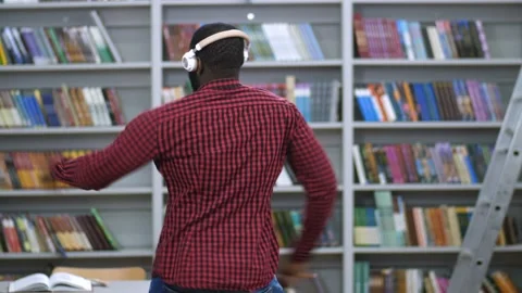 Black man in headphones dancing back to camera Stock Footage 102733470