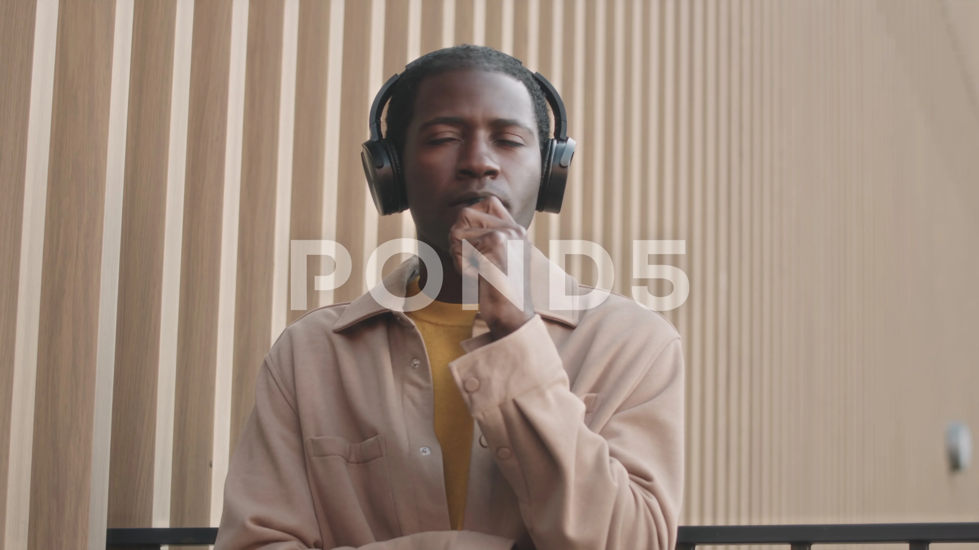 Black Man in Headphones Smoking E Cigarette Outdoors