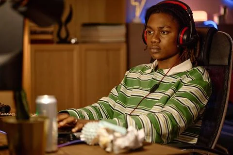 Black Man with Headset Playing Video Games at Computer Stock Photos