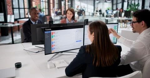 Black Man Installing Computer Software For Diverse Support Service Team. Foto stock