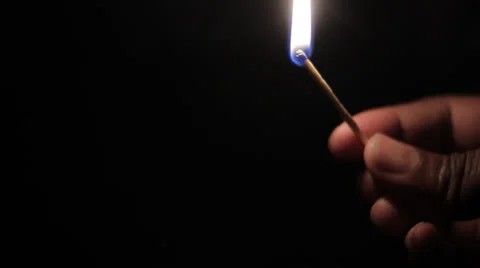 Black man lighting a match in the dark Stock Footage 23052346