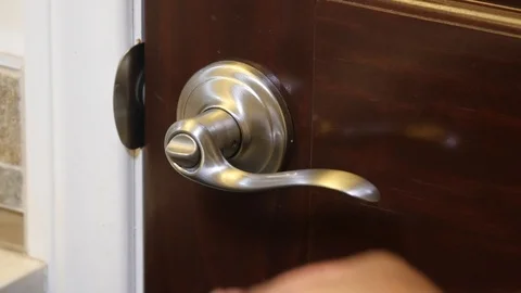 Black man locking and unlocking door handle Stock Footage 126799357