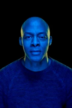 Black man looking at the camera with blue light Stock Photos
